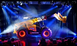 On stage reveal of JCB Loadall Built by Apprentices