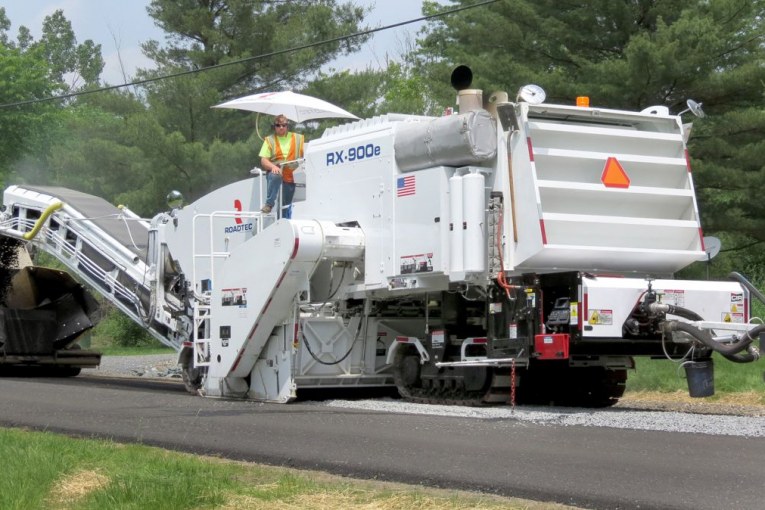 Cold-in-place recycling additive system allows milling and paving a roadway in a single process