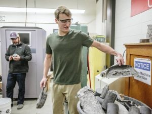 Professor Mike Berry, left, and student researcher Riley Scherr perform compression tests on ultra-high performance concrete on Jan. 11, 2018, at Montana State University. MSU Photo by Adrian Sanchez-Gonzalez