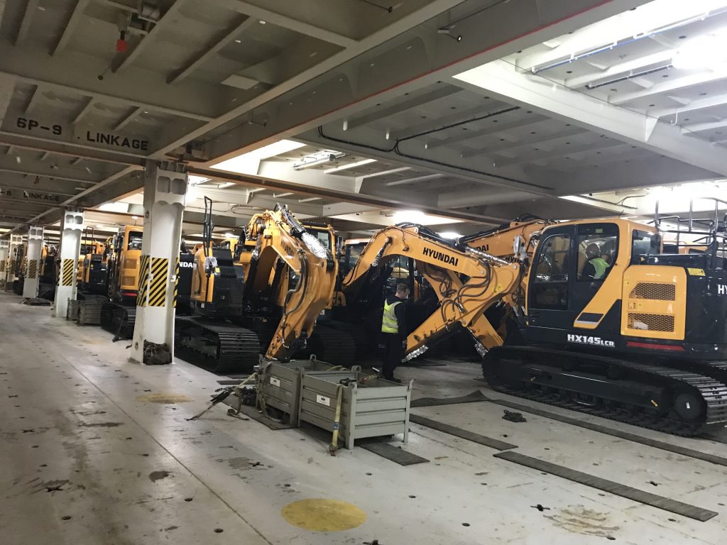 The machines are lashed to the vessel with chains to prevent movement in transit