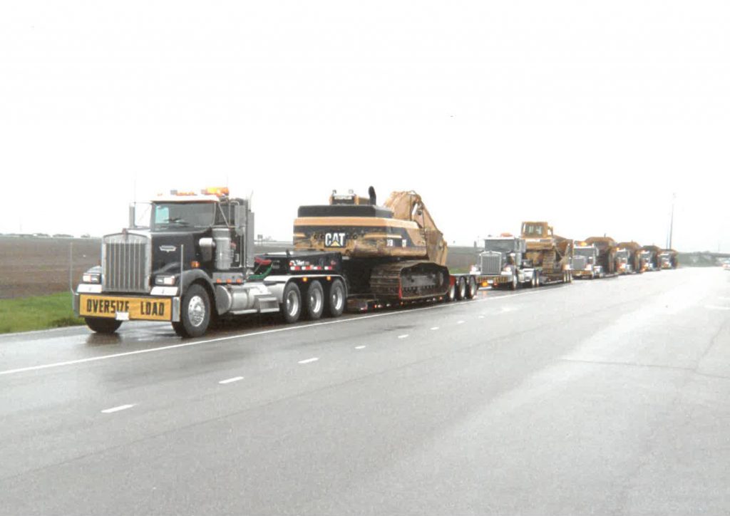 “Off-the-shelf” heavy-haul type trailers allowed Catom Trucking to get by in the early days of the business, but as clients’ equipment grew, so did the need for a custom solution. That’s when the company turned to Talbert Manufacturing for a solution, such as this 55-ton trailer that features raised rails with neck extension as well as a 3-axle jeep and a stinger for a 3+3 rear configuration. (Photo Courtesy of Catom Trucking)
