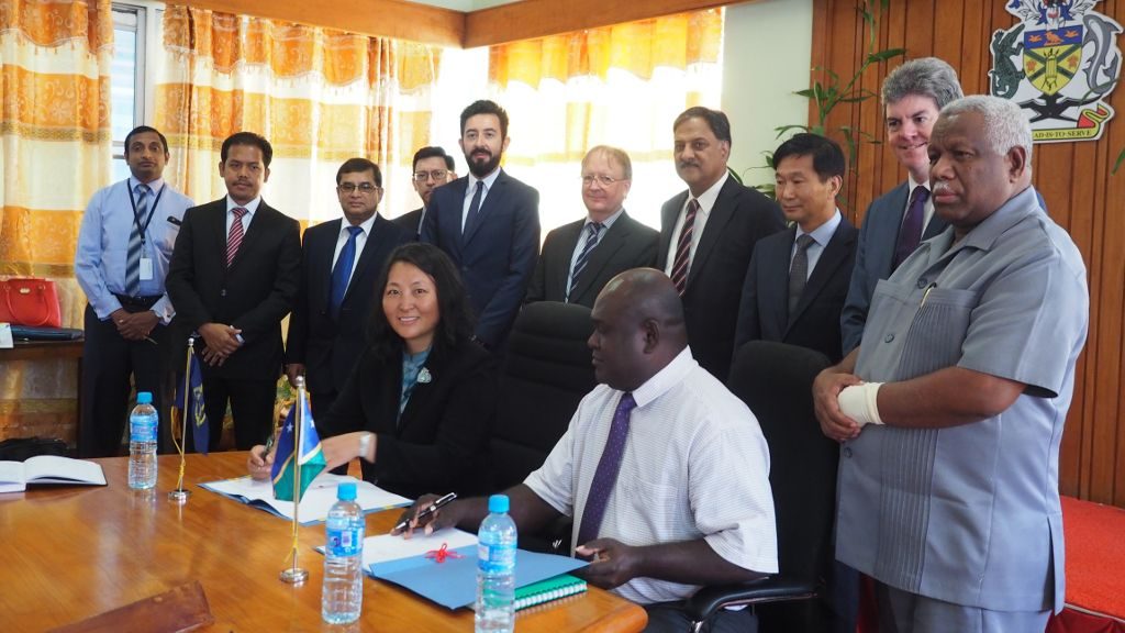 From right: Prime Minister of Solomon Islands Mr. Rick Houinepela (standing), Permanent Secretary for Finance and Treasury Mr. Harry Kuma (seated), and Regional Director of ADB’s Pacific Liaison and Coordination Office Ms. Emma Fan (seated). ADB Executive Directors (standing) visiting Solomon Islands witnessed the event.