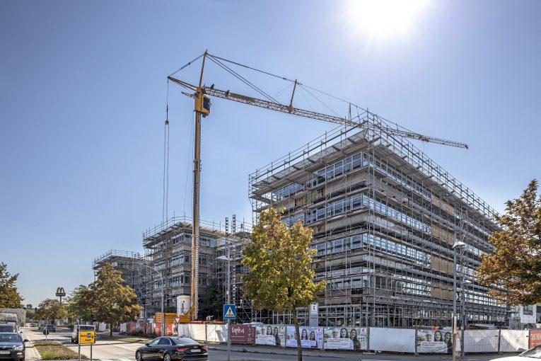 Expert engineers work with Liebherr mobile construction cranes to tackle building retrofit