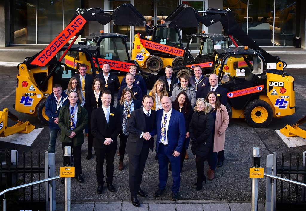 James Richardson of Greenshields JCB (centre, left) seals the deal with Hugh Edeleanu at JCB World Headquarters