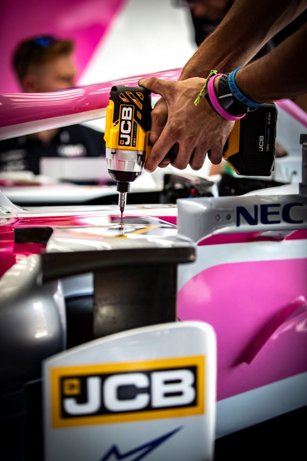 A SportPesa Racing Point F1 team engineer puts the new JCB tools to the test