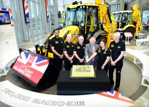 Pictured left to right are Nihal Dhillon, Phil Starbuck, John Plant, JCB Chairman Lord Bamford, Shannon Ramczykowski and Keith Bloor celebrating the production of the 750,000th JCB backhoe loader at JCB World HQ, Rocester, Staffordshire.