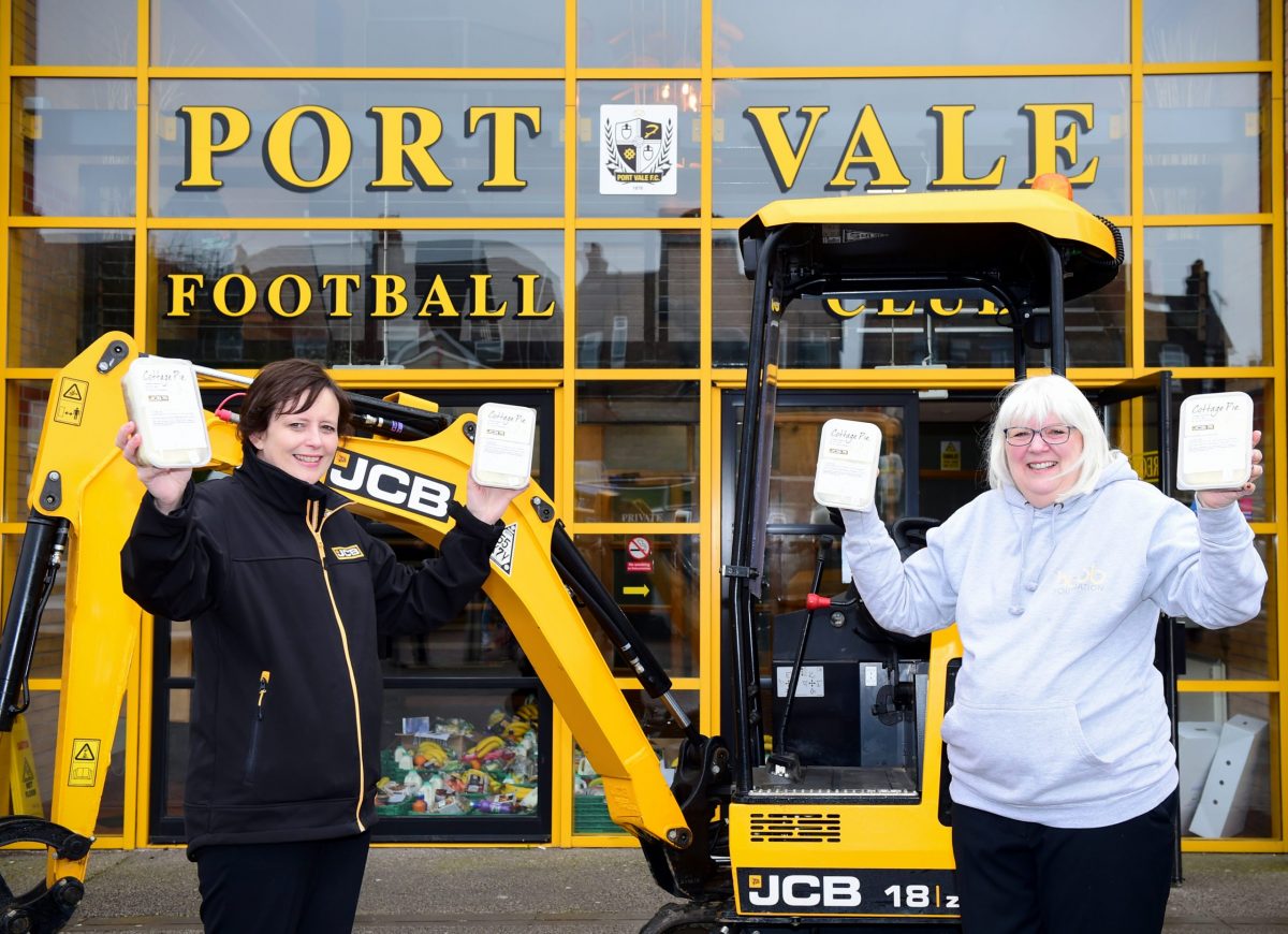 JCB's Liza Parkin (left), part of the team which is helping prepare 2,000 meals for the disadvantaged in Staffordshire delivers the first of the cottage pies to the Hubb Foundation's Founder Carol Shanahan at Port Vale Football Club in Burslem, Stoke-on-Trent.