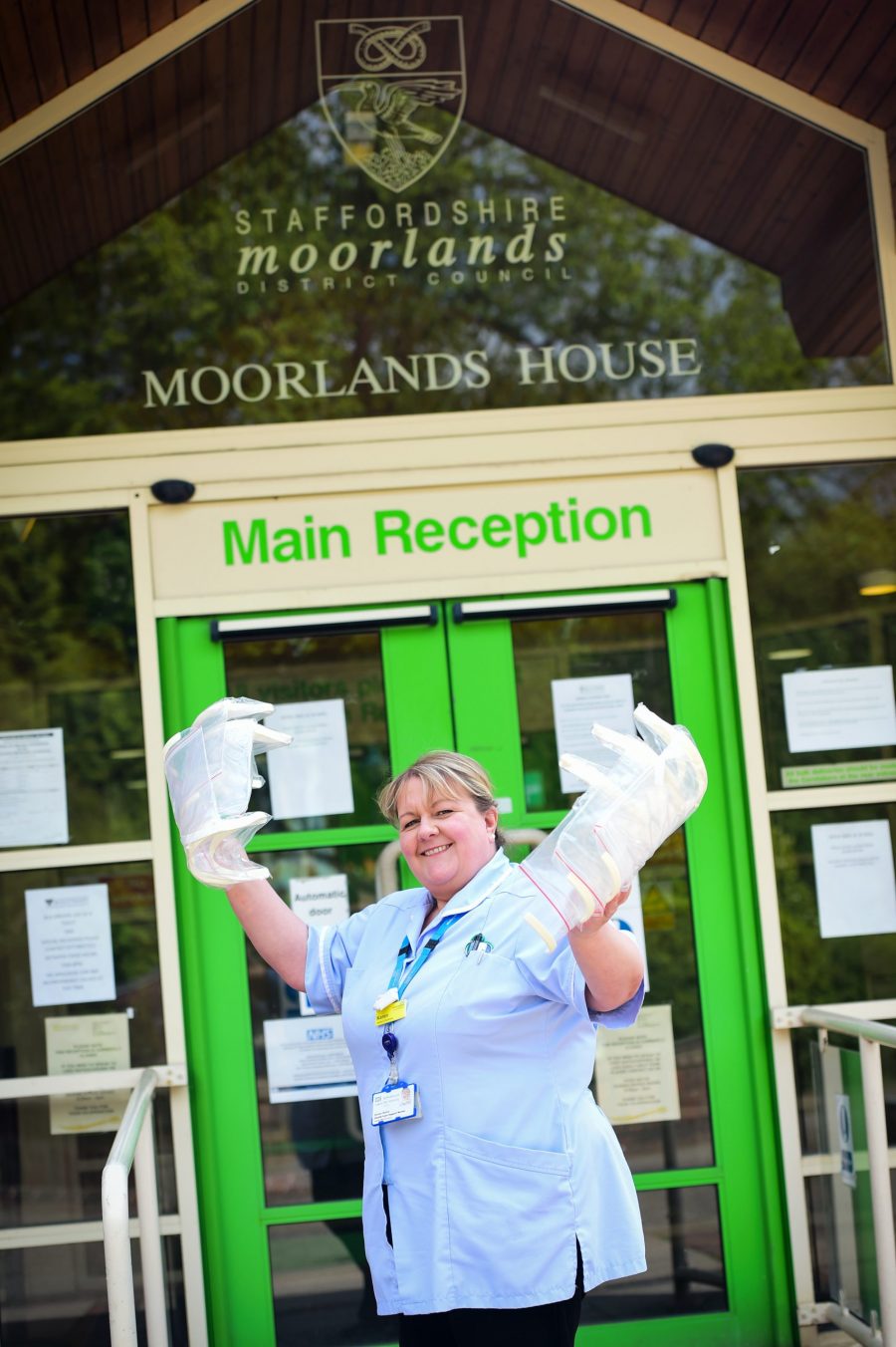 Pictured is Karen Hales (District Nurse) with delivered visors from JCB outside Moorlands House, Leek