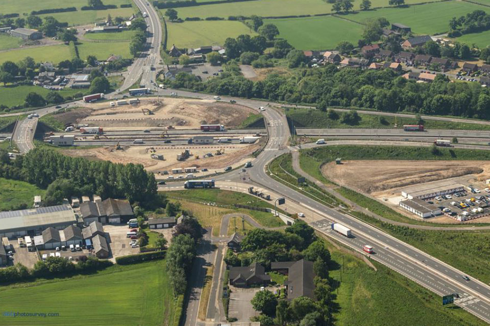 Aerial view of M6 junction 19 improvement project looking from southbound A556 Knutsford to Bowdon bypass and showing work at the roundabout underway and (right of picture) new construction compound between the A556 and M6. Photo © Copyright 360photosurvey.com 2020 all rights reserved