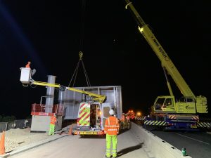 The gantry is lifted into place in the overnight works on the M6 upgrade