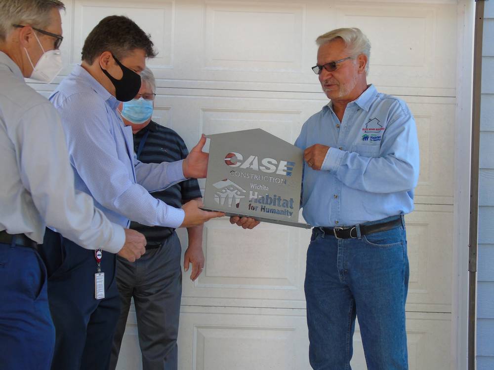 Bill Bauck Wichita Habitat for Humanity Board member presents a plaque to CASE