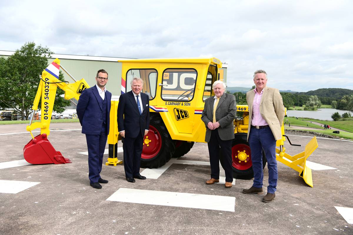 Pictured left to right: George Bamford, Lord Bamford, Roland Carnaby and Roland Carnaby Junior pictured with the newly-restored machine.