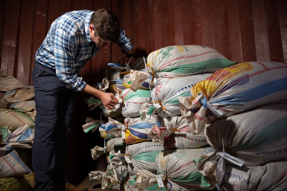 Adam Schafer, director of Supply Chain Sustainability at Intel, inspects bags of ore that have been sealed and tagged to confirm its provenance. A team from Intel's Responsible Minerals Program, as well as representatives of other tech firms, visited mineral-rich Rwanda in November 2019 as part of an industry effort to ensure a legal and ethical supply chain. Tin, tantalum, tungsten and gold mined in the Central African country are key components of silicon chips that run today's smartphones, laptops, servers and other high-tech gear. (Credit: Walden Kirsch/Intel Corporation)