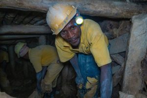 A worker inside a tin mine run by the Comikagi cooperative, near Nyamugali, Rwanda. A team from Intel's Responsible Minerals Program, as well as representatives of other tech firms, visited mineral-rich Rwanda in November 2019 as part of an industry effort to ensure a legal and ethical supply chain. Tin, tantalum, tungsten and gold mined in the Central African country are key components of silicon chips that run today's smartphones, laptops, servers and other high-tech gear. (Credit: Walden Kirsch/Intel Corporation)