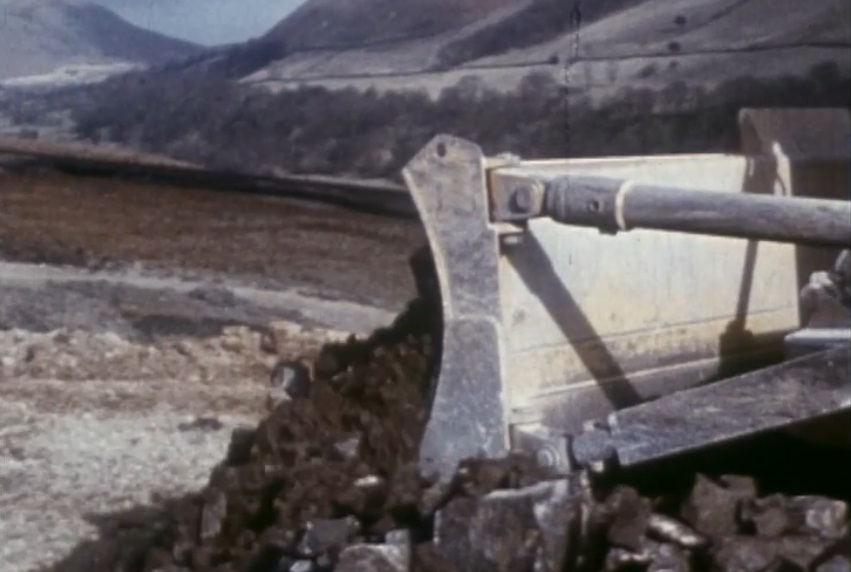 Man and machine v Mother Nature...a dramatic images shows work underway in the spectacular landscape. Images from Laing’s 30 minute documentary courtesy British Film Institute.