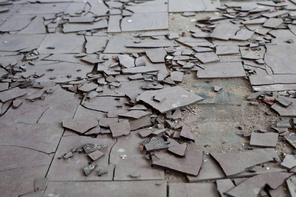 Old and broken asbestos floor tiles