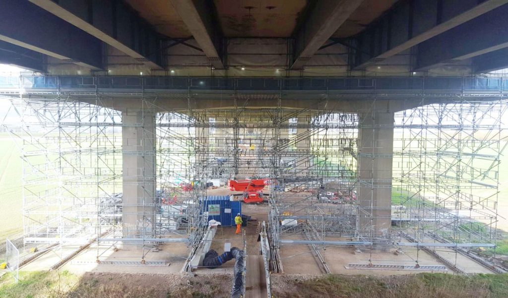 Workers maintaining the M62 in Yorkshire out of sight to the drivers using the bridge