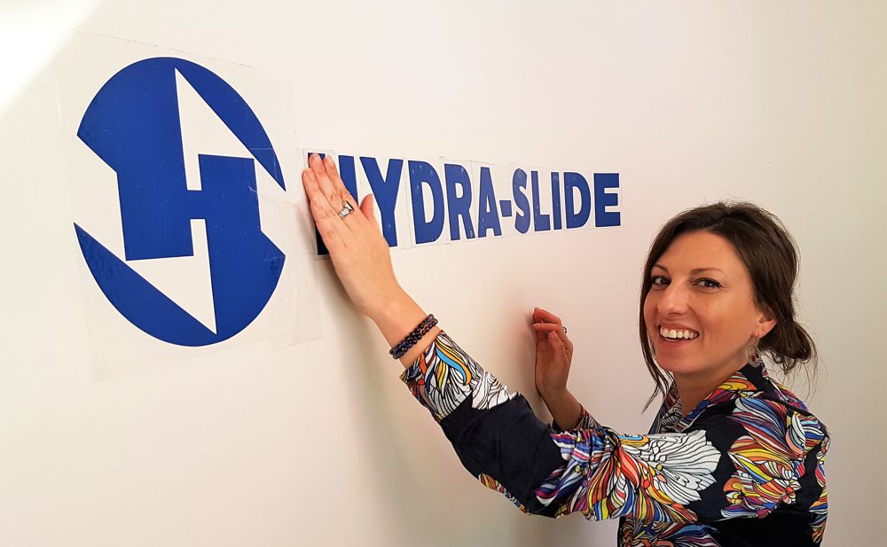 Janine Smith, vice president at Hydra-Slide, unveils the new logo