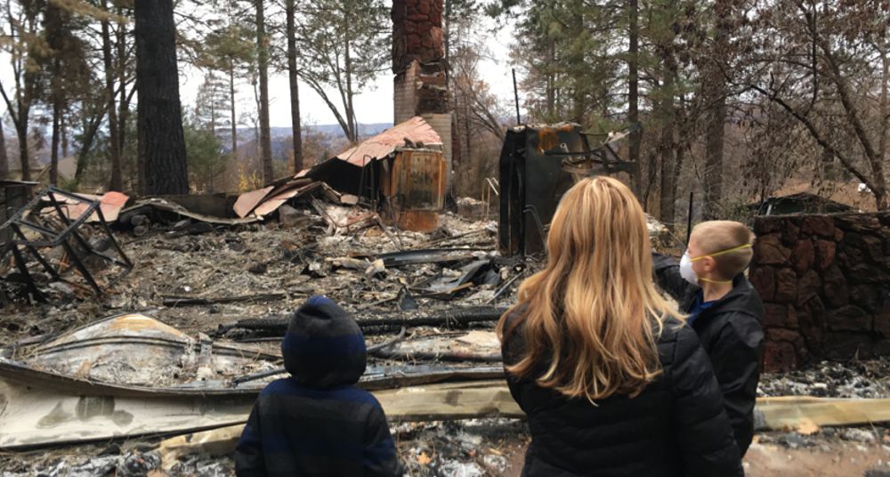 Charles’s wife Jennifer and their two sons on their lot after the fire destroyed their home. Charles Brooks photo