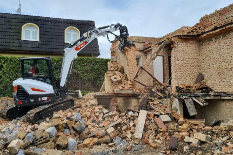 Bobcat construction equipment sets to demolishing 1970's Prague houses