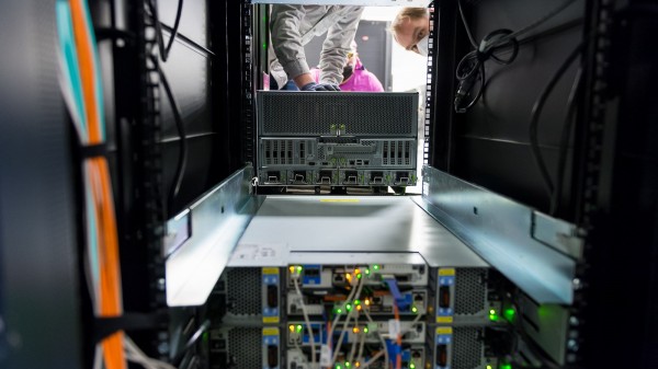 (Image by Argonne National Laboratory.) Engineers inserting ThetaGPU, an AI- and simulation-enabled extension of Argonne’s current supercomputer, Theta. Computing users and operators hope to have more plug-and-play options for hardware upgrades in the future, instead of having to replace entire machines.
