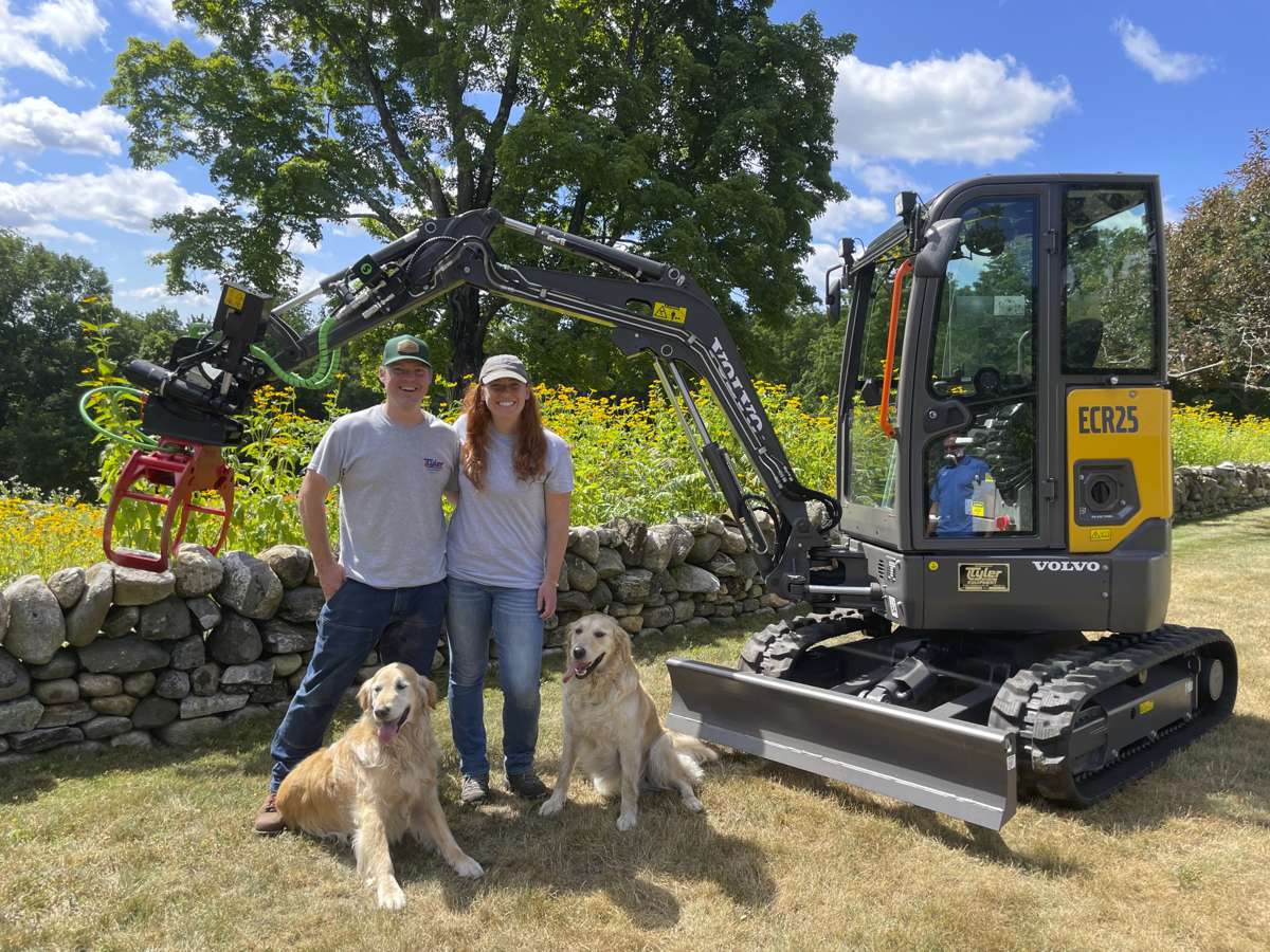 Tylan and Jennifer (and their dogs, Ralph and Daisy) with their new ECR25 Electric compact excavator.