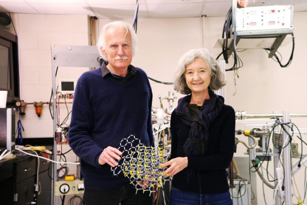 Georgia Tech physicists Walter de Heer and Claire Berger holding an atomic model of graphene on crystalline silicon carbide