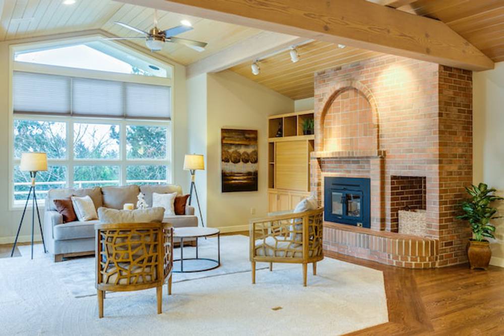 Large living room with a fireplace and a sofa with two chairs and a coffee table in the middle