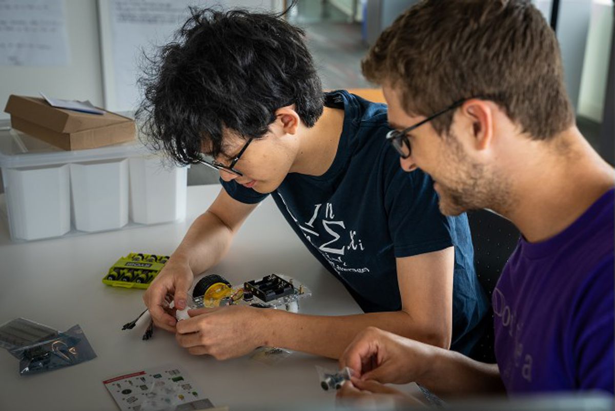 Credit: (Image by Argonne Institutional Partnerships.) Students tinker with their vehicle.