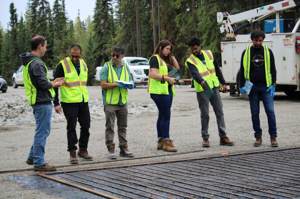 Credit: Rowan University From left to right: Ian Sennstrom, Ayman Ali, Shahriar Abubakri, Caitlin Purdy, Ashith Marath and Ahmed Saidi, all part of Rowan University's Center for Research & Education in Advanced Transportation Engineering Systems, inspect the installation of a testing strip for a system designed to deice pavement in Arctic regions.