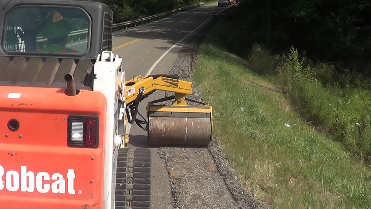 During the Federal Highway Association and Ohio University partnered study, Ohio DOT crew member utilized the Offset Vibratory Roller from Road Widener to compact asphalt alongside a winding road in southeastern Ohio.