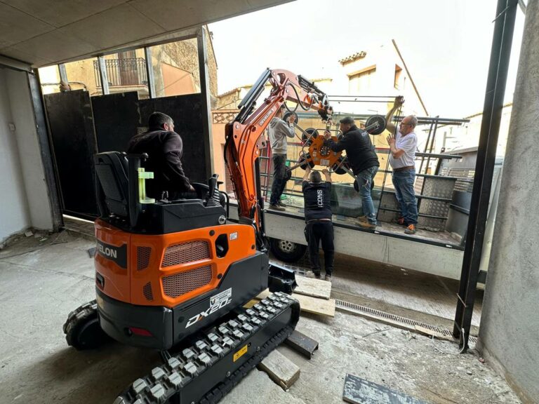 Using a Develon Mini-Excavator to install Large Glass Panels