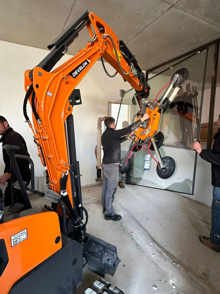 Using a Develon Mini-Excavator to install Large Glass Panels