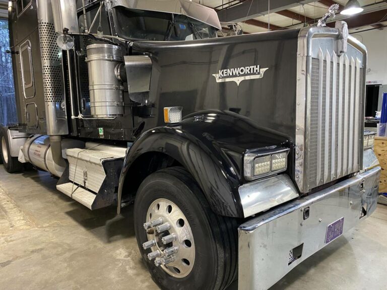 A black Kenworth semi truck with full frontal paint protection film