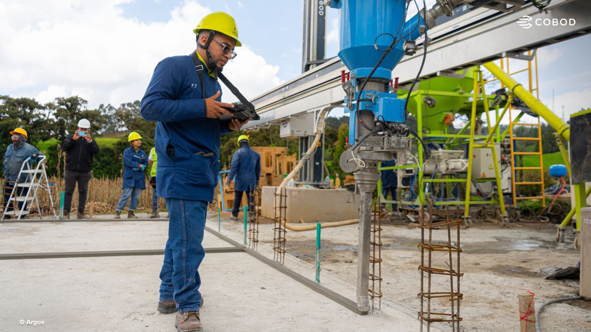 COBOD BOD2 3D printer in operation as the Cementos Argos team monitors on-site 3D printing in Colombia.